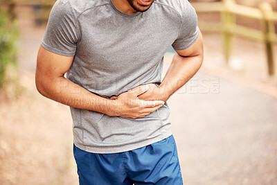 Buy stock photo Fitness, stomach ache and man outdoor after running, workout or exercise. Sports, abdominal pain and male athlete in nature with injury, emergency or problem, sick or hernia after training mockup.
