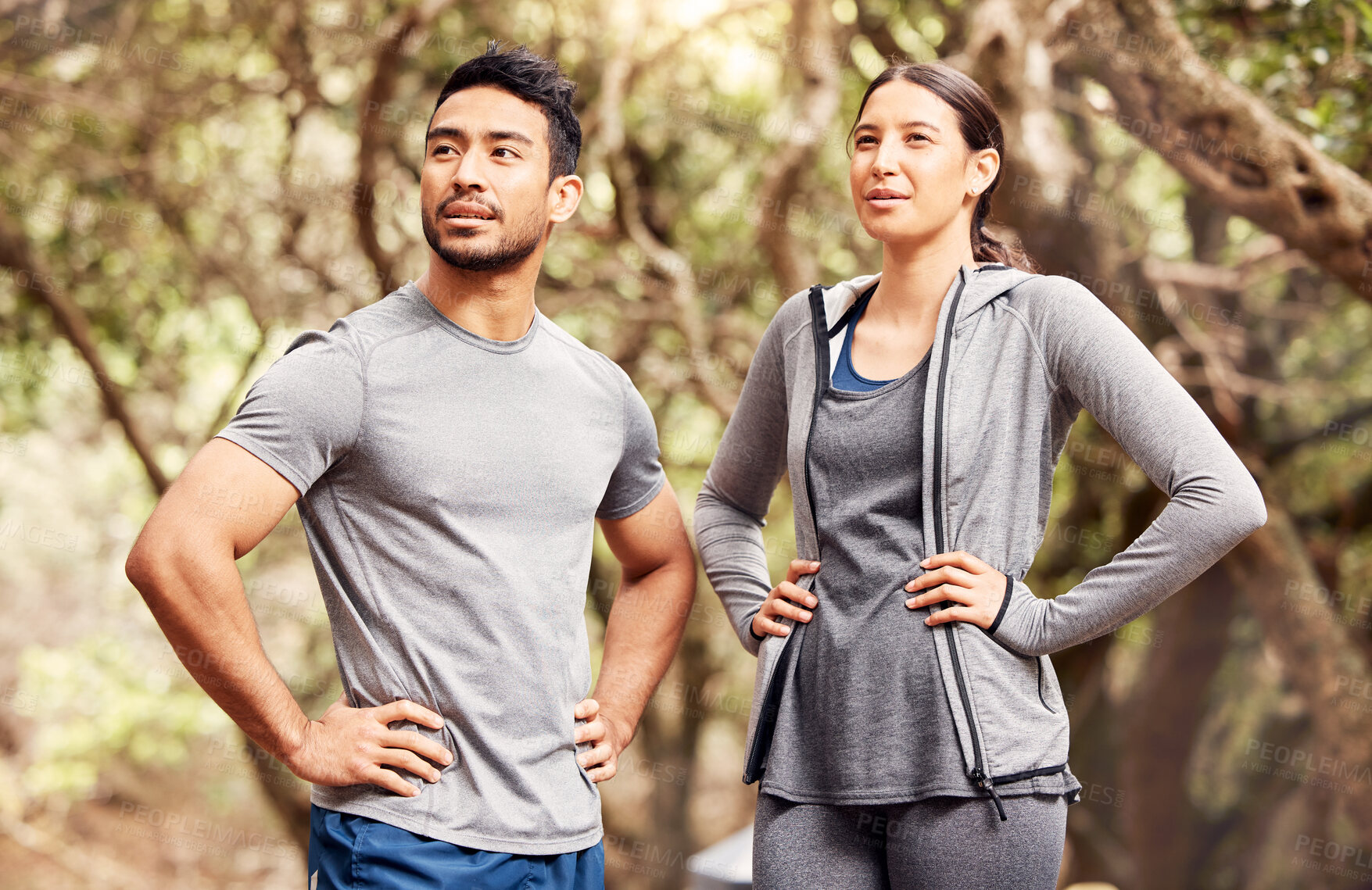 Buy stock photo Shot of a young man and woman going for a run in nature