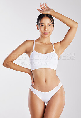 Buy stock photo Shot of a young woman posing in her underwear against a white background