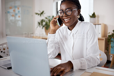 Buy stock photo Shot of a young businesswoman using a laptop and smartphone in a modern office