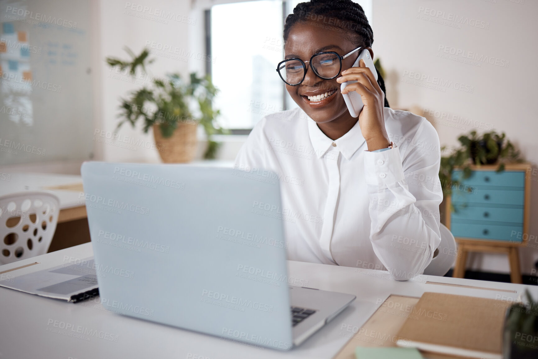 Buy stock photo Shot of a young businesswoman using a laptop and smartphone in a modern office