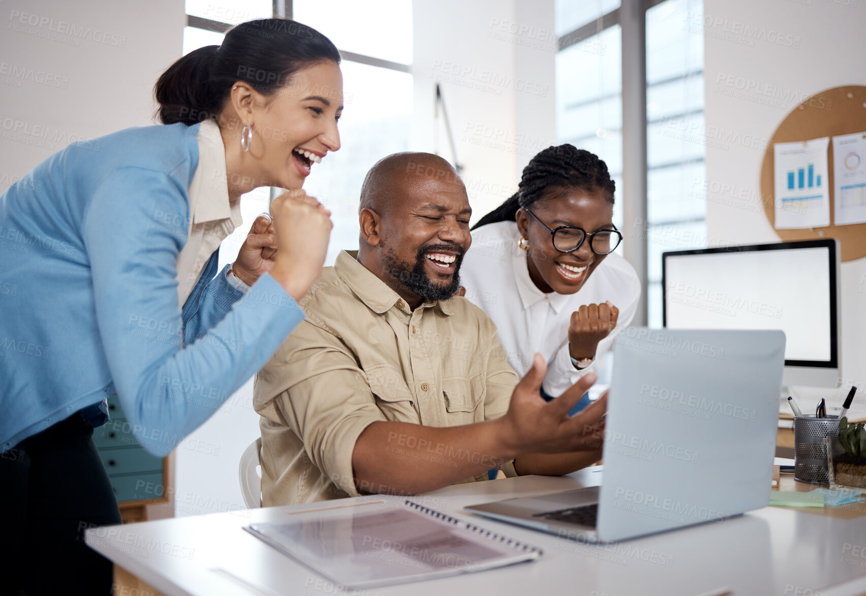 Buy stock photo Shot of a group of businesspeople using a laptop and cheering in a modern office