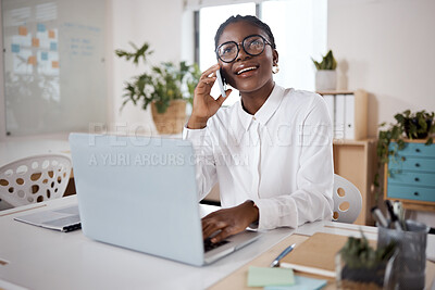 Buy stock photo Shot of a young businesswoman using a laptop and smartphone in a modern office