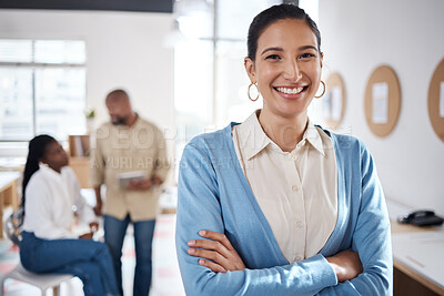 Buy stock photo Portrait of a confident young businesswoman working in a modern office with her colleagues in the background