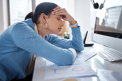 Buy stock photo Shot of a young businesswoman looking stressed while using a laptop at her desk in a modern office
