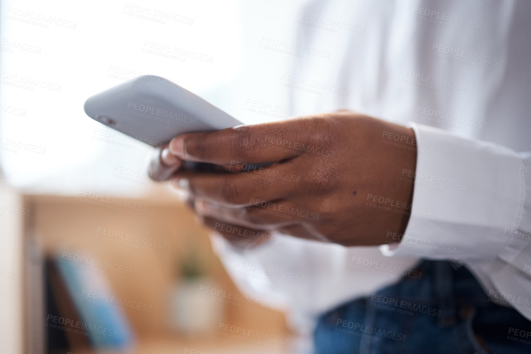 Buy stock photo Shot of an unrecognisable businesswoman using a smartphone in a modern office