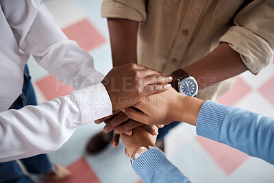 Buy stock photo Shot of a group of unrecognisable businesspeople joining their hands in solidarity in a modern office