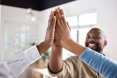 Buy stock photo Shot of a group of businesspeople giving each other a high five in a modern office