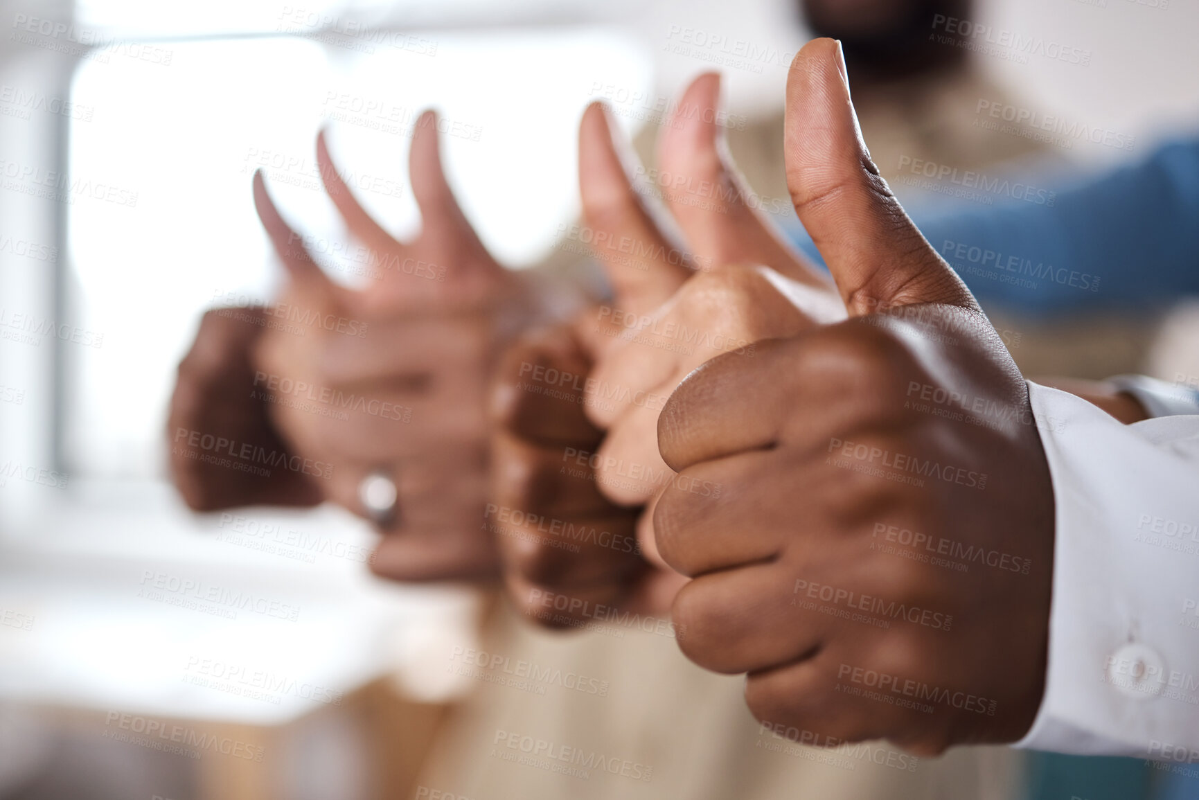 Buy stock photo Shot of a group of unrecognisable businesspeople showing thumbs up in a modern office