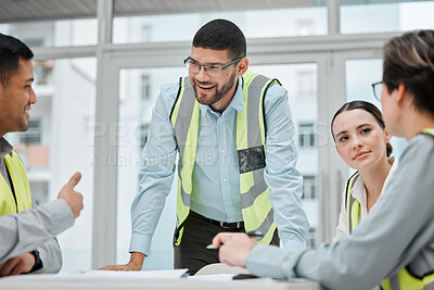 Buy stock photo Cropped shot of a group of young constructions having a meeting on their building site