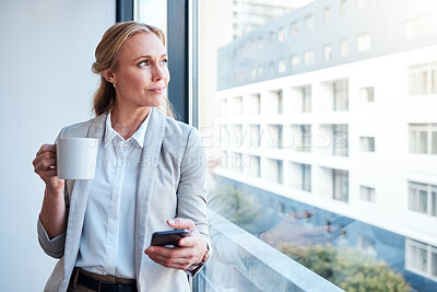 Buy stock photo Thinking, coffee and woman with a phone at work for a break, social media or a vision at window. Office, ideas and a corporate employee with tea and a mobile for an app, chat or email in the morning