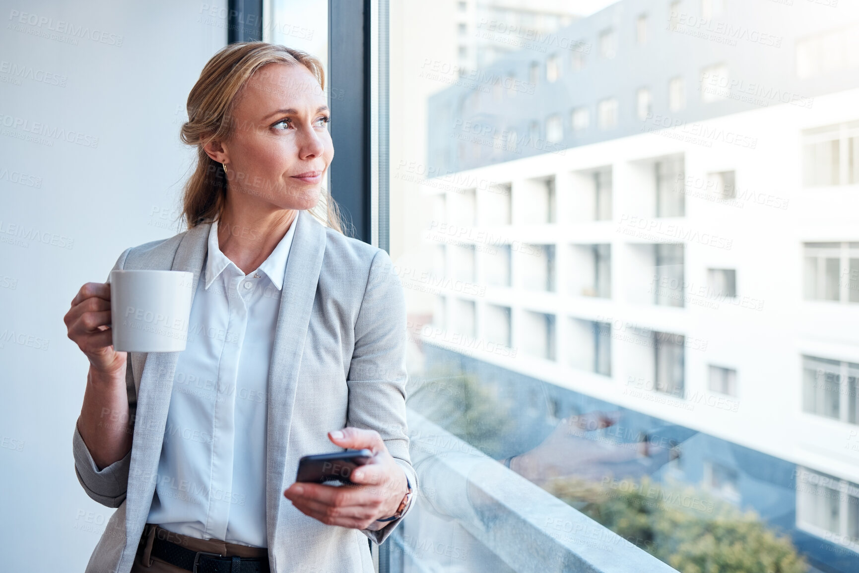 Buy stock photo Thinking, coffee and woman with a phone at work for a break, social media or a vision at window. Office, ideas and a corporate employee with tea and a mobile for an app, chat or email in the morning