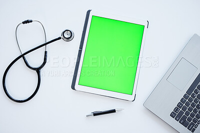 Buy stock photo Tablet, green screen and stethoscope on desk in hospital for wellness, app or ui with mock up space. Digital touchscreen, laptop and medical tools for communication, telehealth and services in clinic