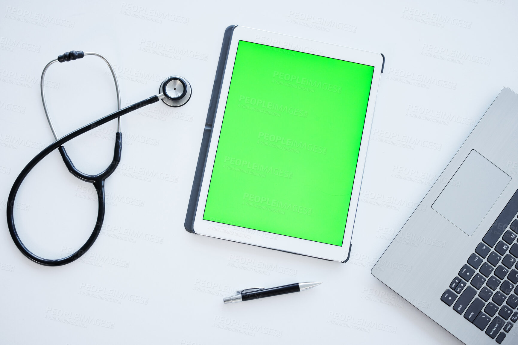 Buy stock photo Tablet, green screen and stethoscope on desk in hospital for wellness, app or ui with mock up space. Digital touchscreen, laptop and medical tools for communication, telehealth and services in clinic