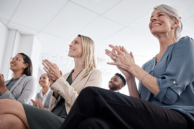 Buy stock photo Low angle shot of businesspeople applauding during a meeting in an office