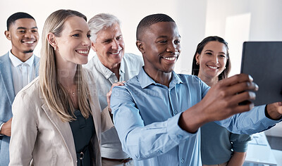 Buy stock photo Shot of a group of businesspeople taking selfies together on a digital tablet in an office