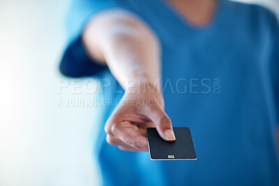 Buy stock photo Shot of an unrecognisable doctor showing you a credit card
