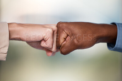 Buy stock photo Shot of two unrecognisable businesspeople bumping fists