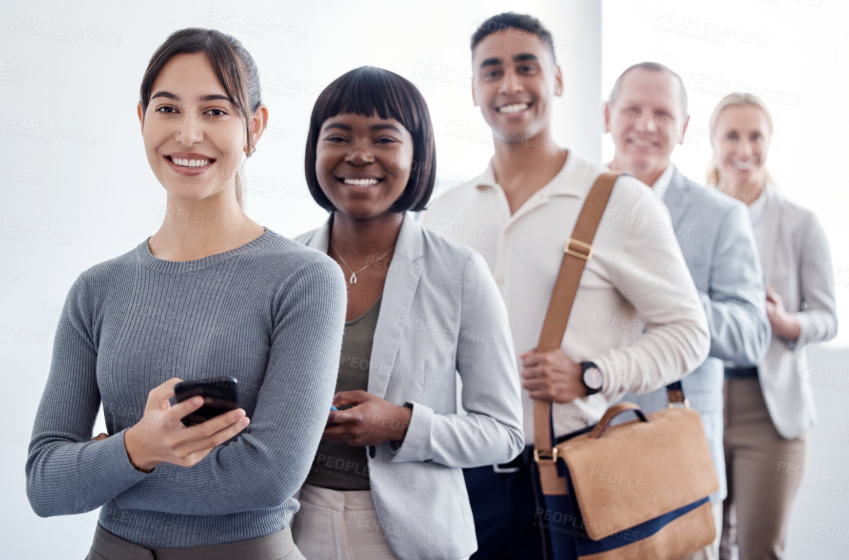 Buy stock photo Shot of a group of new employees waiting in a line to complete their interview