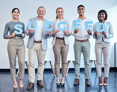 Buy stock photo Shot of a group of businesspeople each holding a letter that spells 