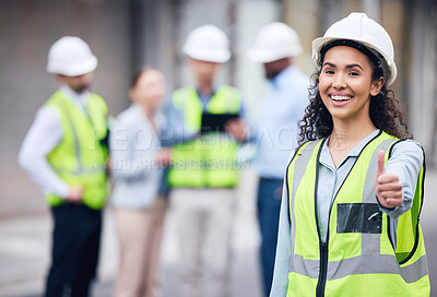 Buy stock photo Thumbs up, woman construction worker and at a industrial workplace happy with her colleagues in the background. Thank you or success, agreement and cheerful or excited architect at building site
