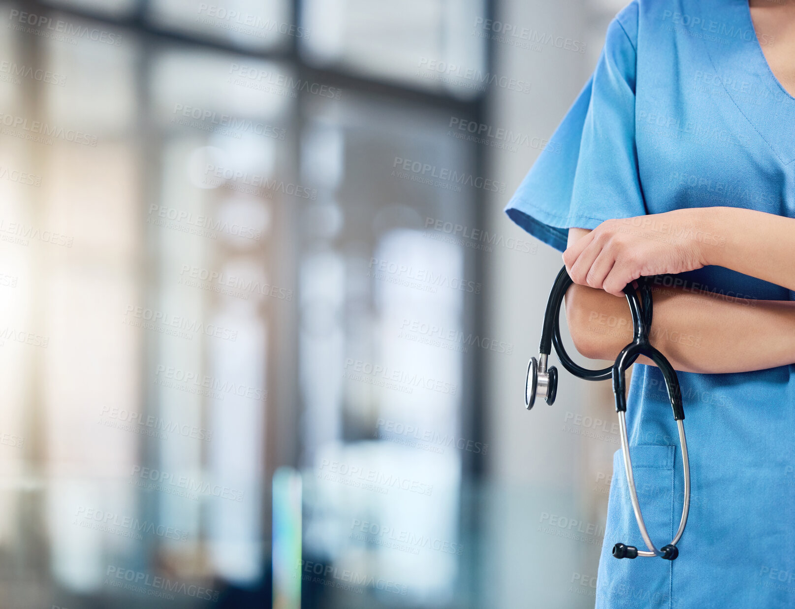 Buy stock photo Shot of an unrecognizable doctor holding a stethoscope at a hospital