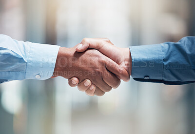 Buy stock photo Shot of two unrecognizable businesspeople shaking hands in an office at work