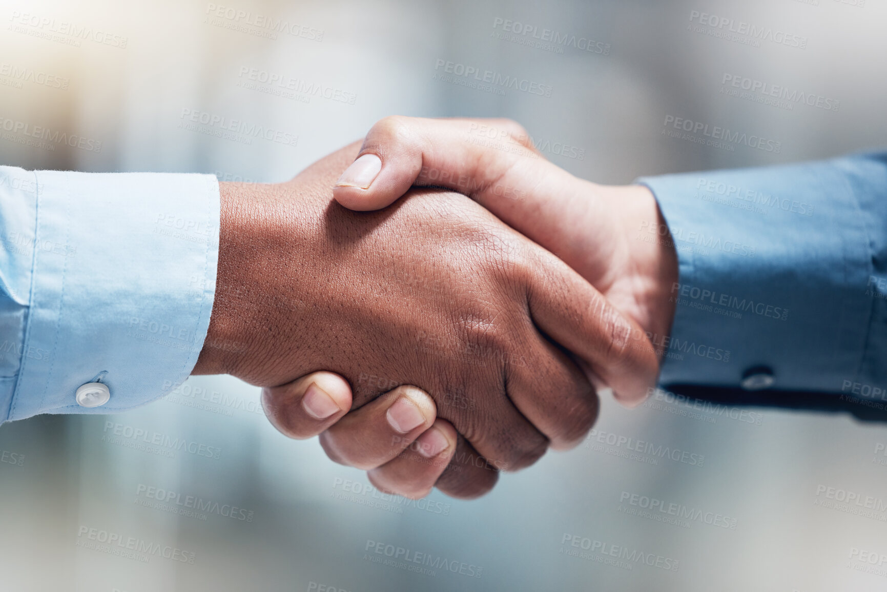 Buy stock photo Shot of two unrecognizable businesspeople shaking hands in an office at work