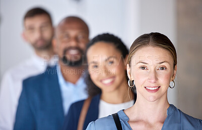 Buy stock photo Shot of a group of businesspeople standing in a line at an office