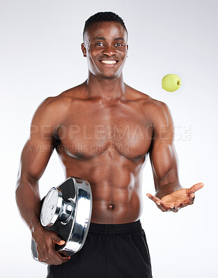 Buy stock photo Diet, scale and man with apple in portrait for health, studio or training to lose weight on white background. Throw, detox nutrition or happy black model with fruit, fitness or bodybuilding progress