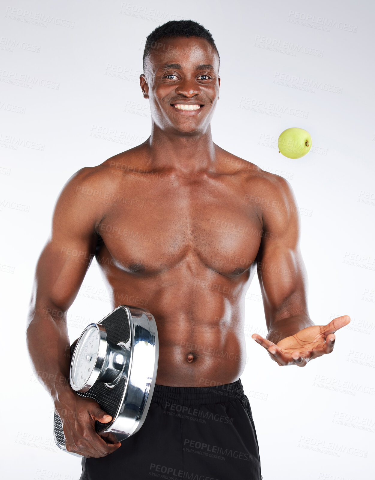 Buy stock photo Diet, scale and man with apple in portrait for health, studio or training to lose weight on white background. Throw, detox nutrition or happy black model with fruit, fitness or bodybuilding progress