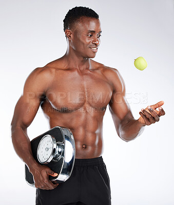 Buy stock photo Diet, scale and man with apple in studio for health, choice or training to lose weight on white background. Throw, detox nutrition or happy black model with fruit, fitness or bodybuilding progress