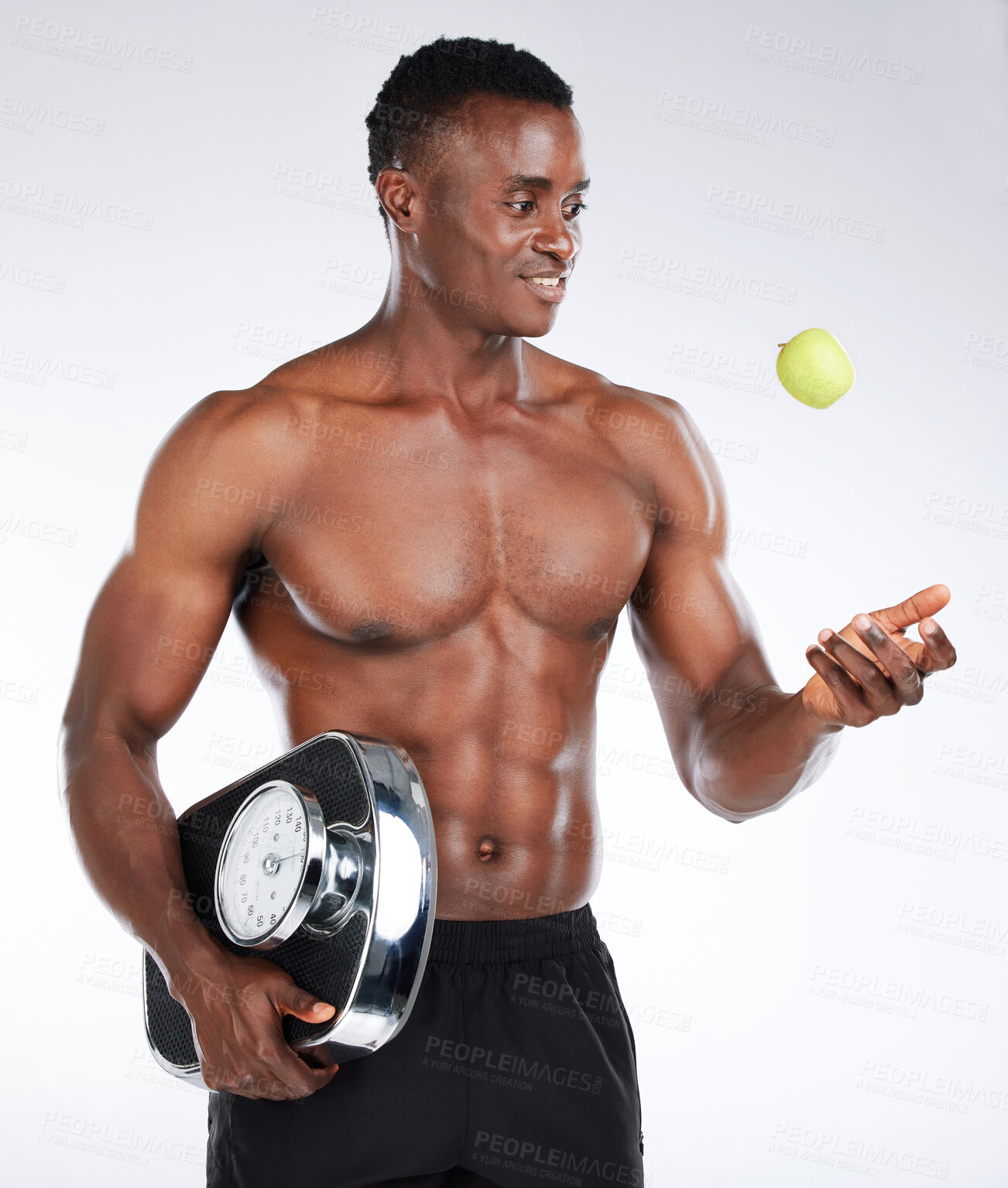 Buy stock photo Diet, scale and man with apple in studio for health, choice or training to lose weight on white background. Throw, detox nutrition or happy black model with fruit, fitness or bodybuilding progress