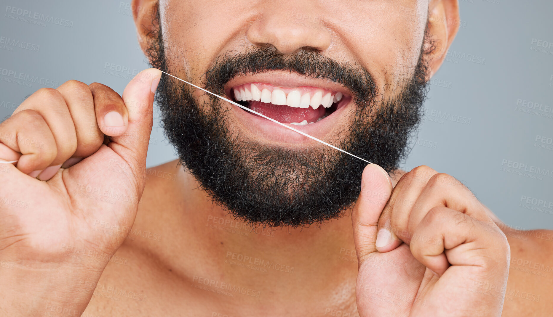 Buy stock photo Oral health, floss and mouth of man in studio for hygiene, plaque removal or clean with thread. Male person, organic product or dental wellness on gray background for fresh breath, routine or care