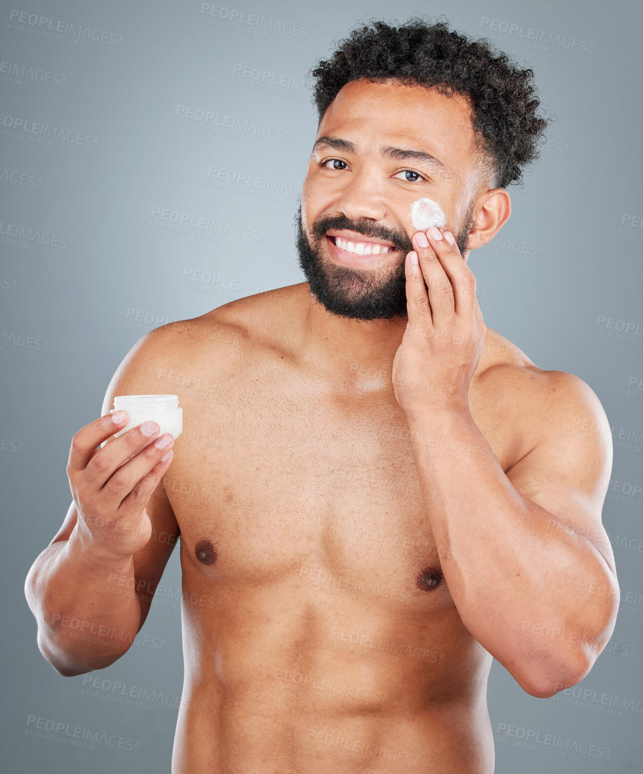 Buy stock photo Jar, cream and portrait of man in studio for skincare, facial treatment and skin tone or hydration. Male person, lotion and sunscreen for uv protection on gray background, closeup and grooming.