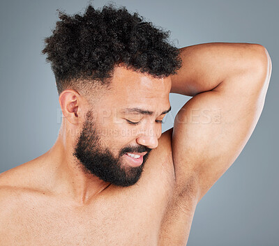 Buy stock photo Man, studio and smelling deodorant on armpit, hygiene and topless for clean scent on gray background. Male person, shirtless and underarm for cologne aroma, smile and satisfaction for perfume odor