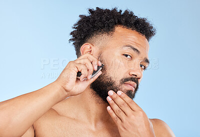 Buy stock photo Electric razor, portrait or man in studio for grooming, hair removal or beard care in morning. Male person, shaver or thinking of trim for routine, epilation and personal hygiene on blue background