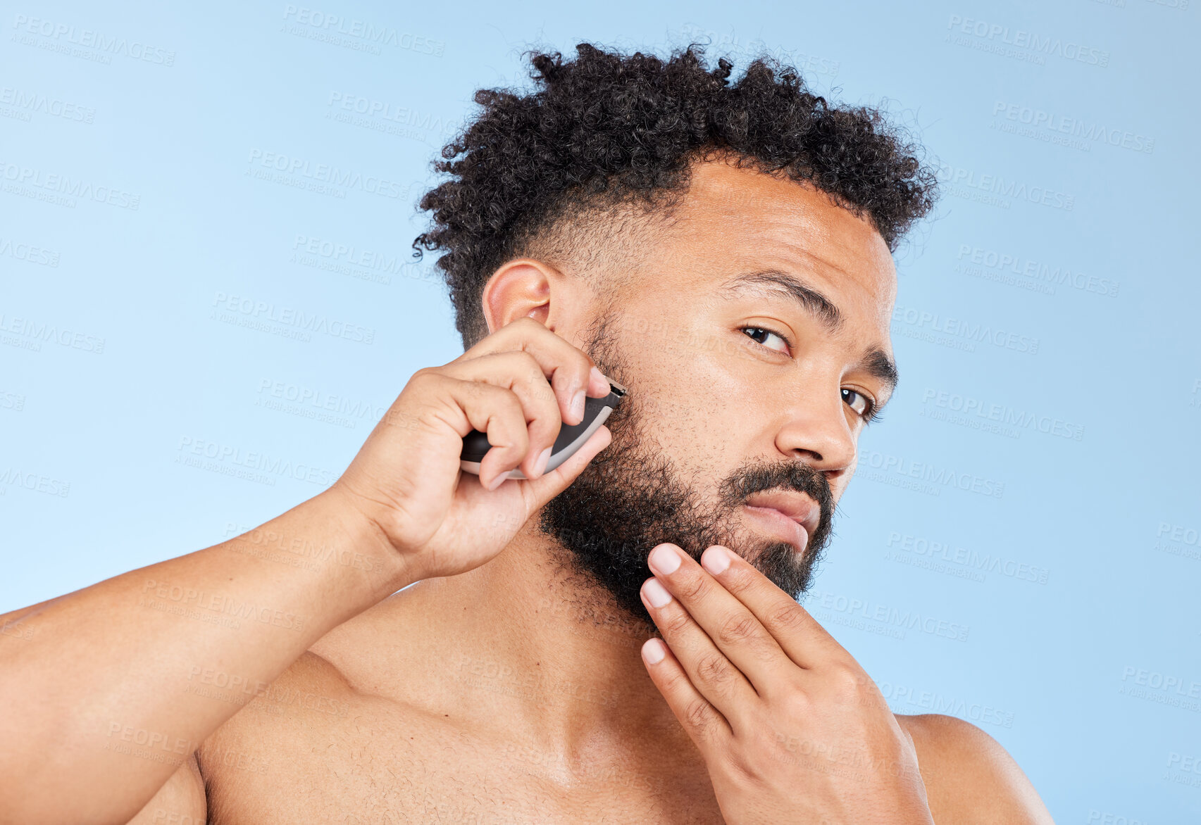 Buy stock photo Electric razor, portrait or man in studio for grooming, hair removal or beard care in morning. Male person, shaver or thinking of trim for routine, epilation and personal hygiene on blue background