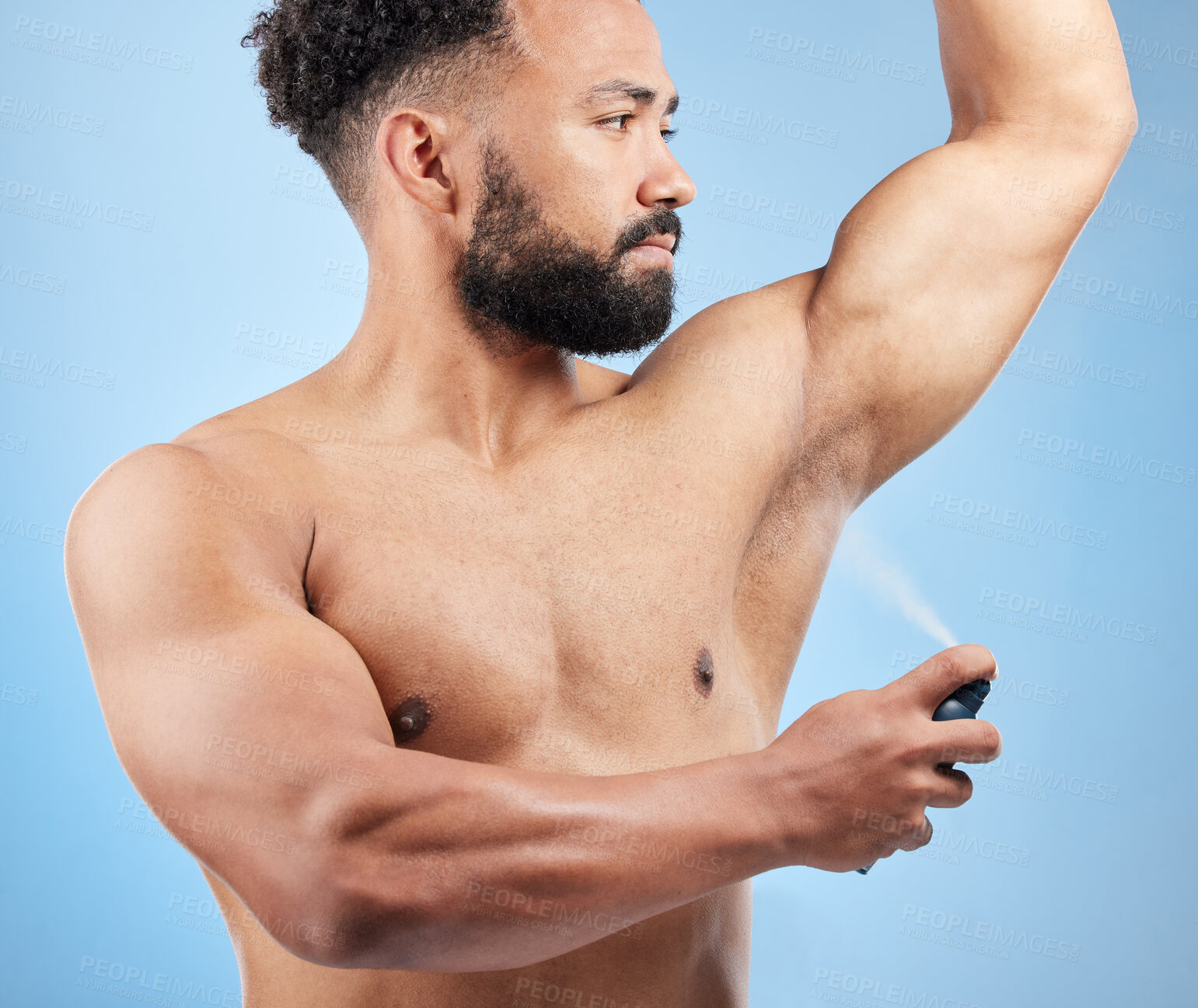 Buy stock photo Man, apply deodorant and spray armpit in studio, mist and grooming cosmetics on blue background. Male person, underarm and fragrance for hygiene treatment, clean smell and antiperspirant for sweating