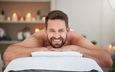 Buy stock photo Portrait, relax and massage with a man lying in spa for wellness treatment at a luxury resort for health. Bed, care or beauty and a happy male customer smile for stress relief with aromatherapy