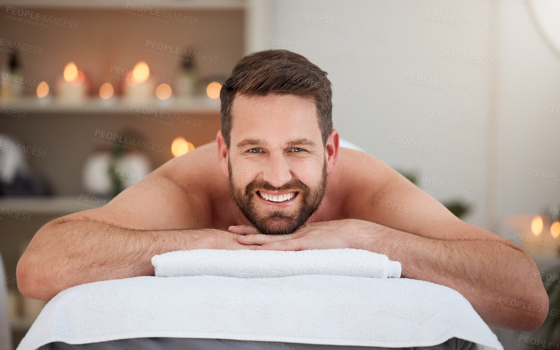 Buy stock photo Portrait, relax and massage with a man lying in spa for wellness treatment at a luxury resort for health. Bed, care or beauty and a happy male customer smile for stress relief with aromatherapy