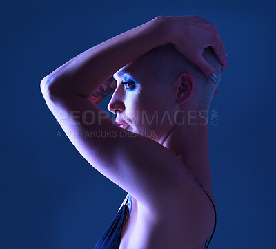 Buy stock photo Studio shot of an attractive young woman wearing edgy makeup against a blue background