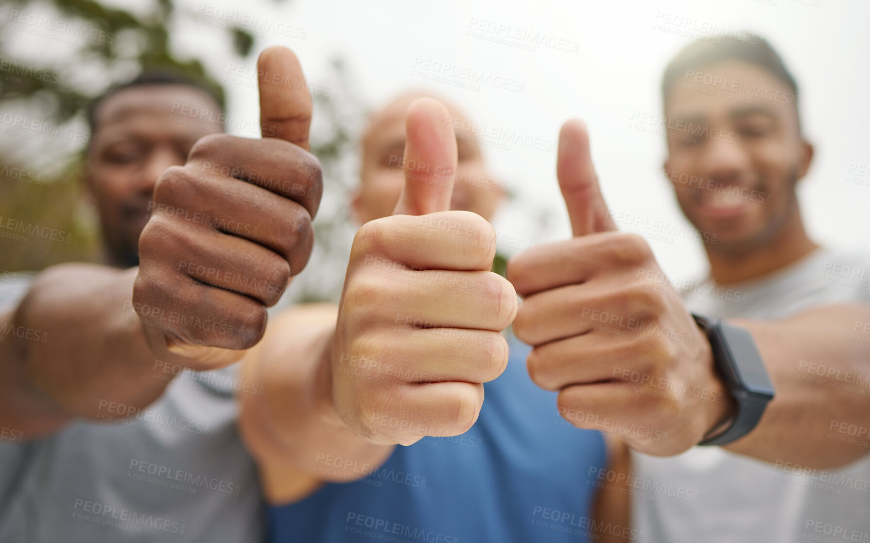 Buy stock photo Closeup shot of a group of unrecognisable men showing thumbs up while exercising outdoors