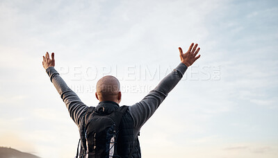 Buy stock photo Rearview shot of an unrecognizable young man enjoying the view during his hike in the mountains