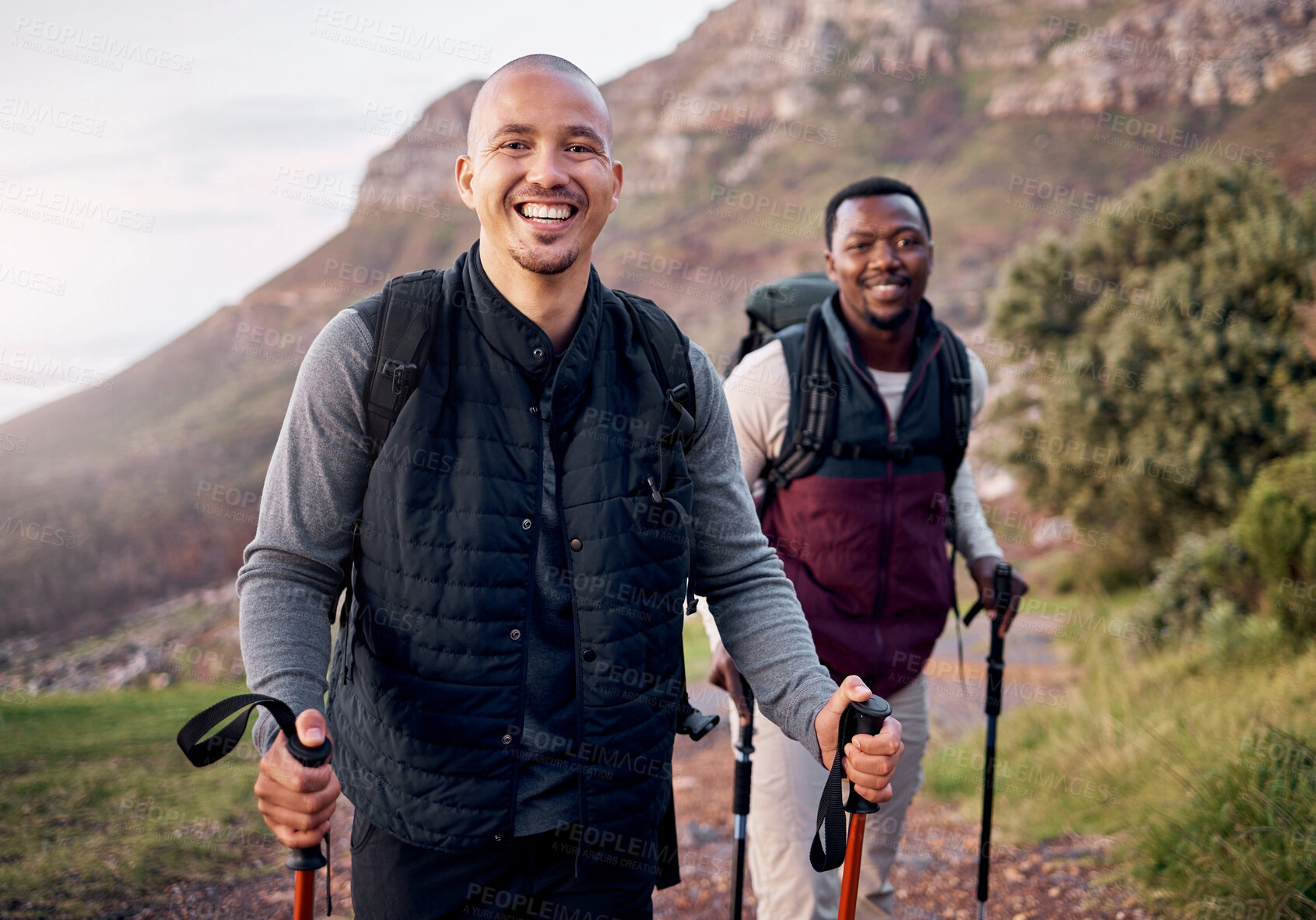 Buy stock photo Cropped portrait of two handsome young men hiking in the mountains