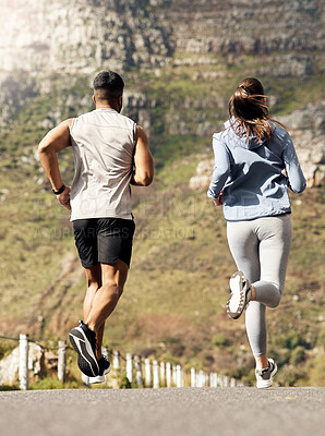 Buy stock photo Shot of a couple out for a run on a mountain road