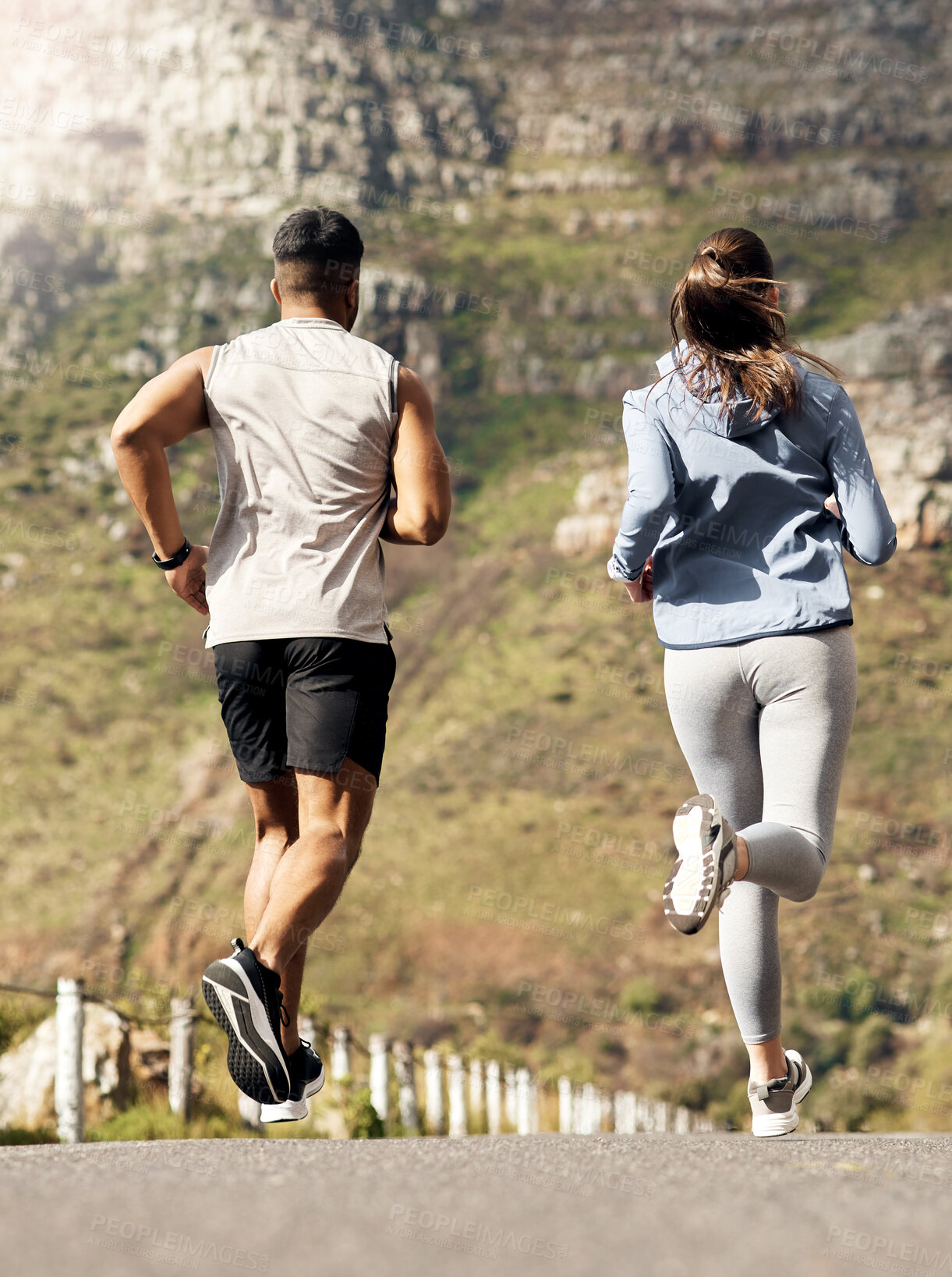 Buy stock photo Shot of a couple out for a run on a mountain road