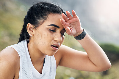Buy stock photo Shot of a woman looking exhausted while out for a run