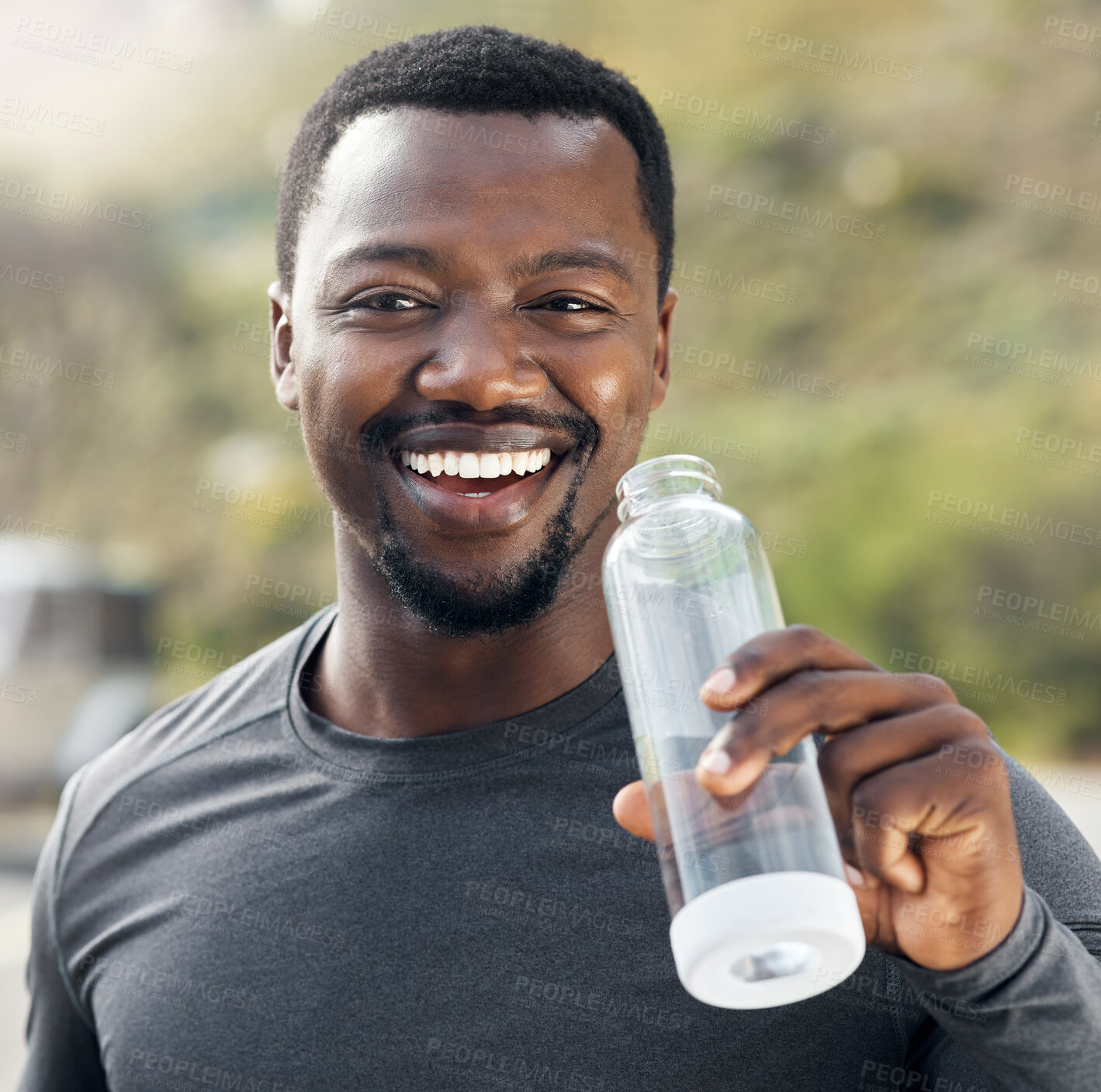 Buy stock photo Shot of a man drinking water while out for a workout