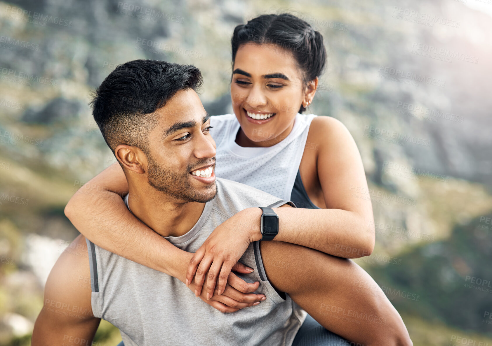 Buy stock photo Shot of a man carrying his girlfriend on his back while out for a workout